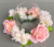 Candle ring with artificial large peach roses and blossom