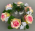 Candle ring with artificial pink-green roses and gypsophila