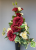 Spike vase with dark red yellow roses
