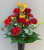 Spike vase with dark red carnations and yellow freesia